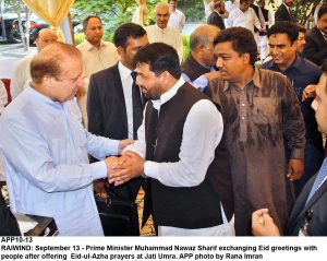 APP10-13 RAIWIND: September 13 - Prime Minister Muhammad Nawaz Sharif exchanging Eid greetings with people after offering Eid-ul-Azha prayers at Jati Umra. APP photo by Rana Imran