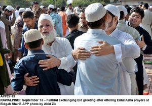 APP27-13 RAWALPINDI: September 13 Faithful exchanging Eid greeting after offering Eidul Azha prayers at Eidgah Sharif. APP photo by Abid Zia