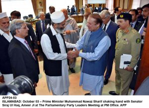 APP24-03 ISLAMABAD: October 03 Prime Minister Muhammad Nawaz Sharif shaking hand with Senator Siraj Ul Haq, Ameer JI at The Parliamentary Party Leaders Meeting at PM Office. APP
